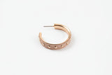 Rose gold hoop earring with embedded stones on a white background