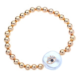 14k Gold Filled Bead Ball Stretch Bracelet with evil eye on a freshwater coin pearl.